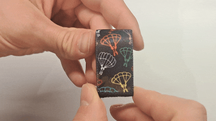 Dual-sided Squote Chest Strap Keepers securely attached to skydiving straps, showcasing premium quality and secure fit.