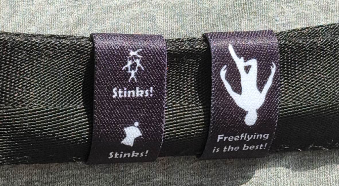 Dual-sided Squote Chest Strap Keepers securely attached to skydiving straps, showcasing premium quality and secure fit.