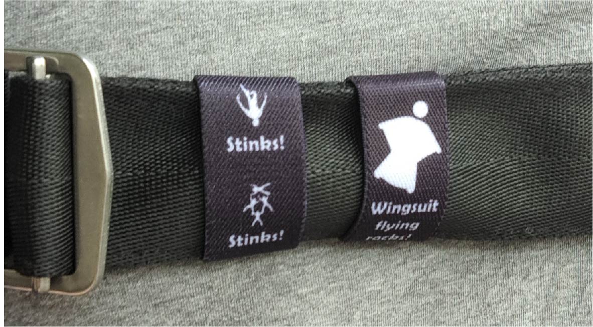 Dual-sided Squote Chest Strap Keepers securely attached to skydiving straps, showcasing premium quality and secure fit.